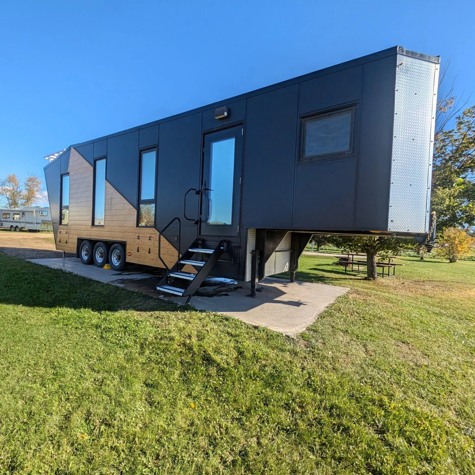 The completed Tiny House Master Plan build — a black-clad gooseneck trailer with cedar accents