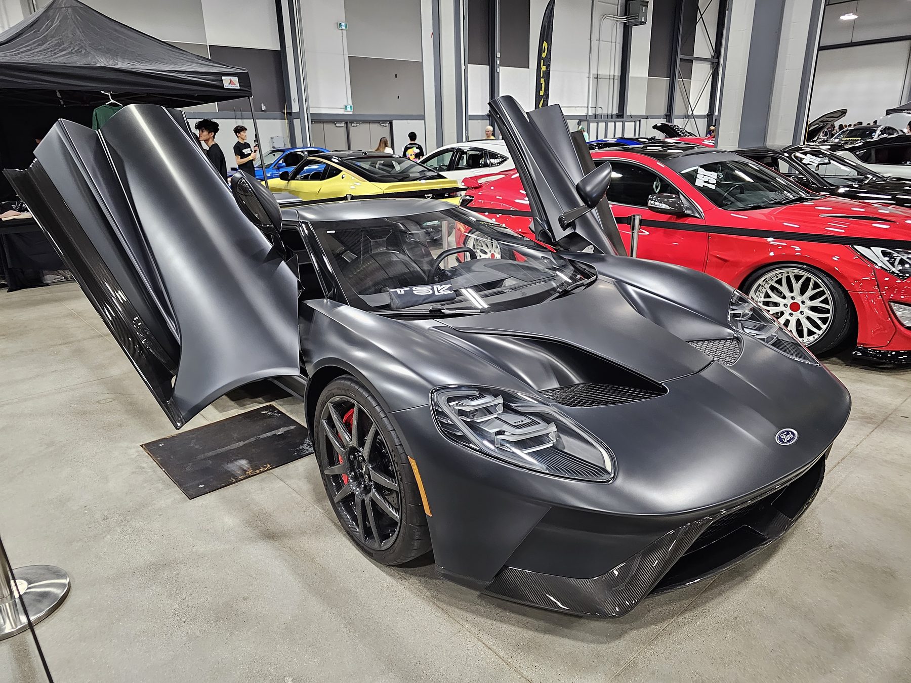 A matte black 2nd-generation Ford GT with carbon-fibre dihedral doors open