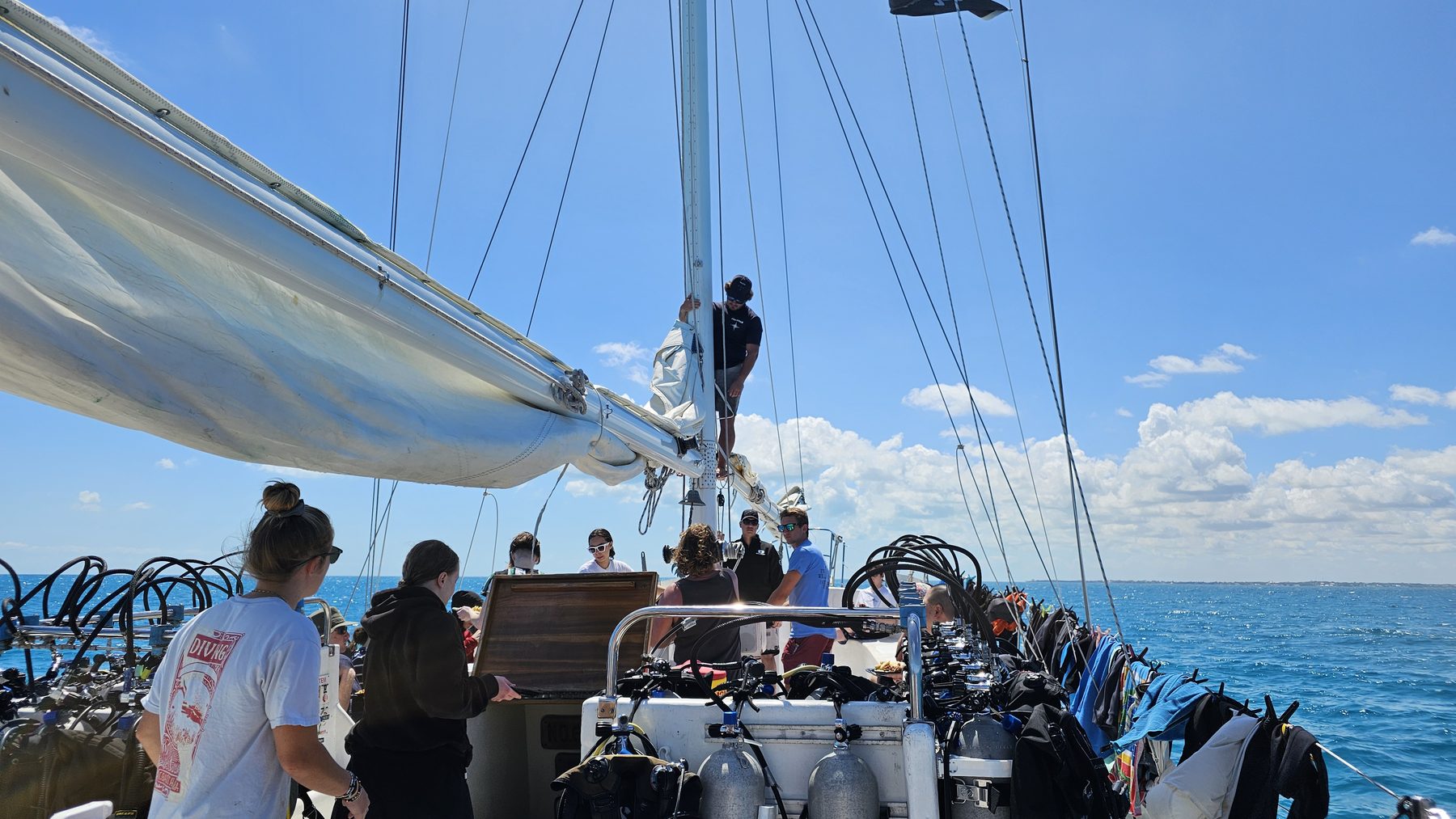 The deck of Blackbeards Cruises sailboat with the dive crew preparing tanks