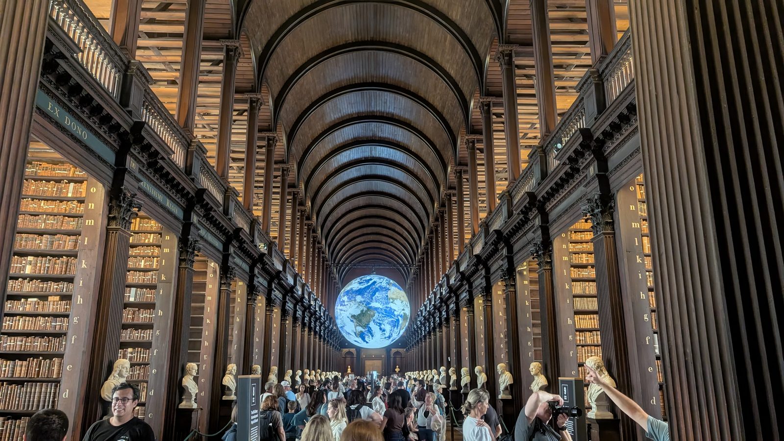 The Long Room at Trinity College Library, Dublin, with the Earth installation suspended in the central aisle