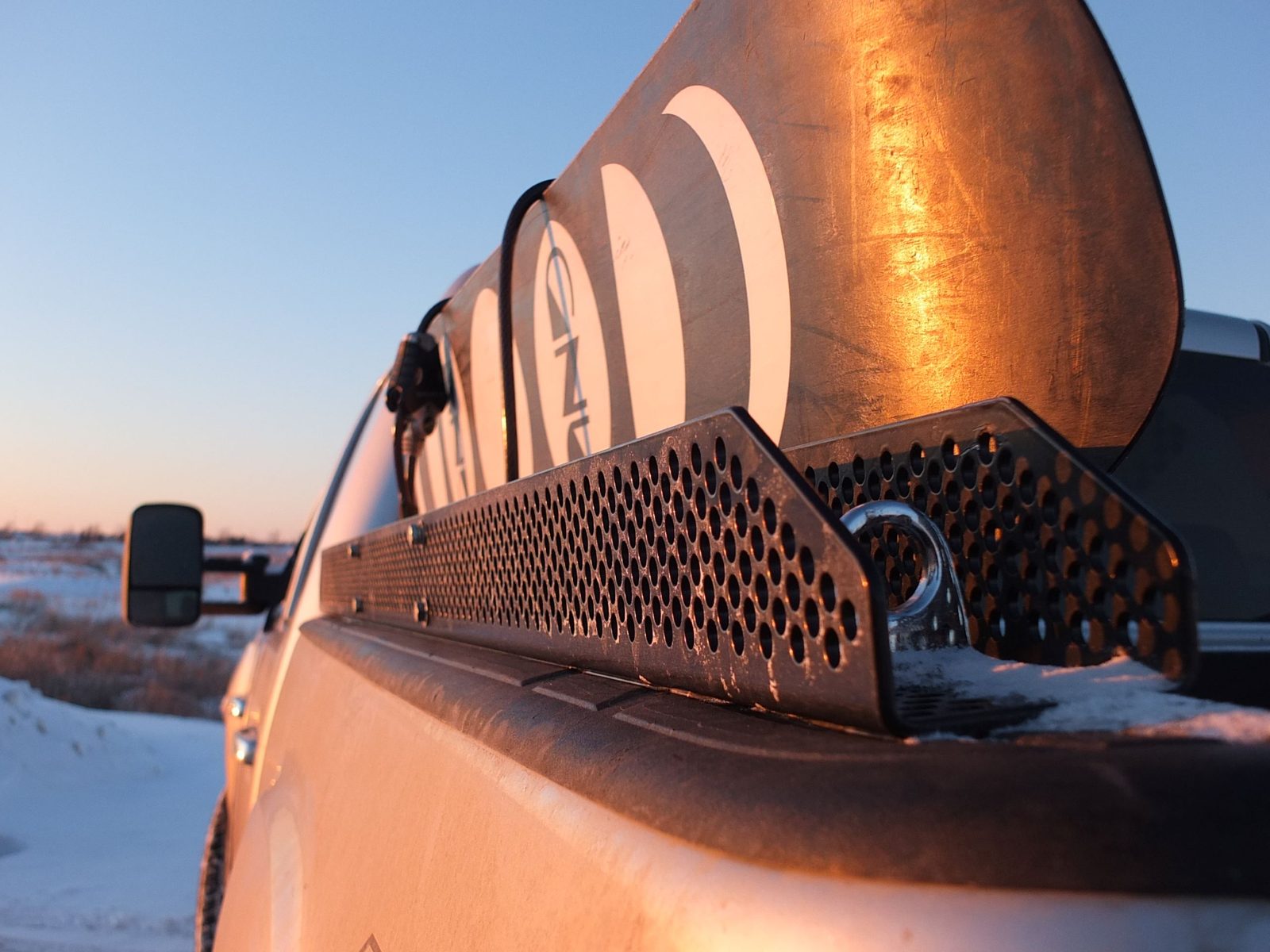 A custom-fabricated steel rack mounted to the back of a truck